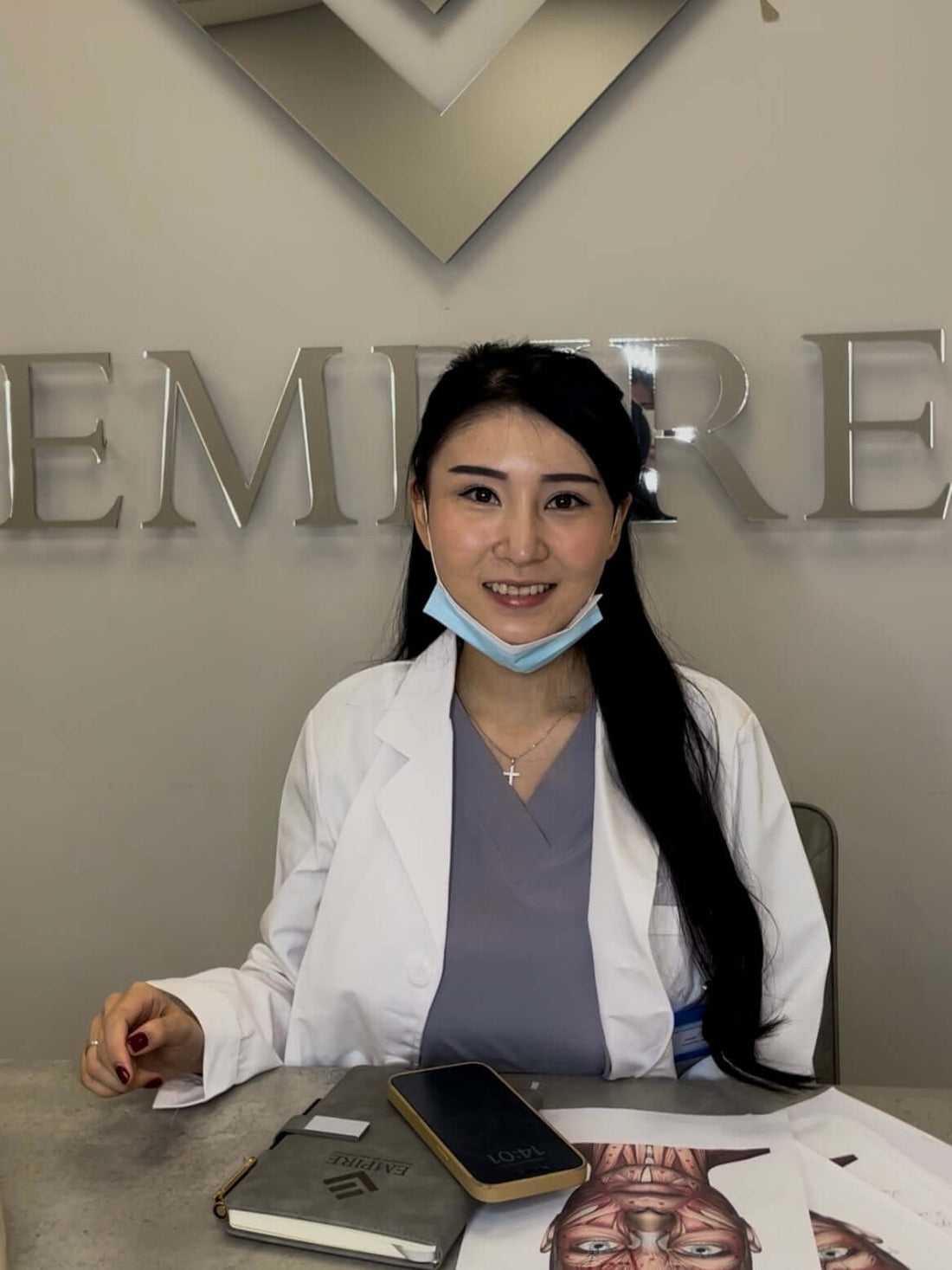 CPD Accredited Aesthetics Courses expert at a clinic, smiling and wearing a lab coat.
